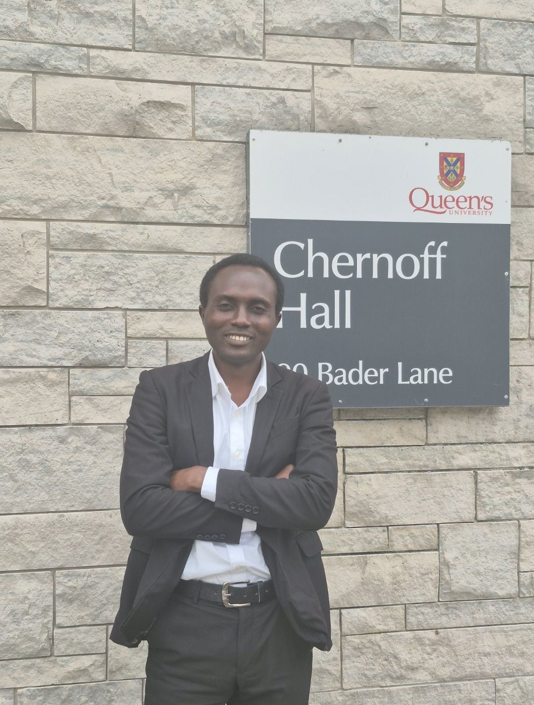 Dr. Andrew Omame outside Chernoff Hall at Queen's University